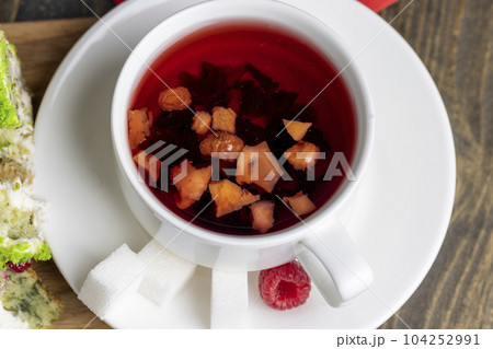 Red raspberry tea with pieces of fruit and berries 104252991