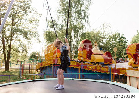 Happy schoolgirl having fun at an adventure park on a summer day. High quality photo Happy schoolgirl having fun at an adventure park on a summer day. High quality photo 104253394