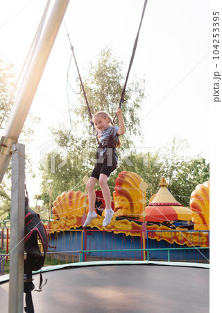 Happy schoolgirl having fun at an adventure park on a summer day. High quality photo Happy schoolgirl having fun at an adventure park on a summer day. High quality photo 104253395