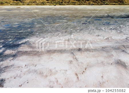 Dry muddy soil surface coverd by salt for background texture Dry muddy soil surface coverd by salt for background texture 104255082