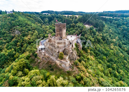 aerial view rock with medieval castle Ehrenburg on it near moselle river in Brodenbach with forest hills 104265076