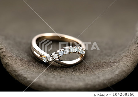stunning close up shot of a single wedding rings, delicately intertwined to symbolize the everlasting bond of love and commitment. Jewelry gold diamond ring for anniversary, valentine, or engagement. 104269360