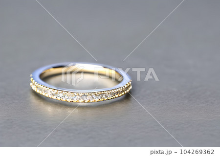stunning close up shot of a single wedding rings, delicately intertwined to symbolize the everlasting bond of love and commitment. Jewelry gold diamond ring for anniversary, valentine, or engagement. stunning close up shot of a single wedding rings, delicately intertwined to symbolize the everlasting bond of love and commitment. Jewelry gold diamond ring for anniversary, valentine, or engagement. 104269362