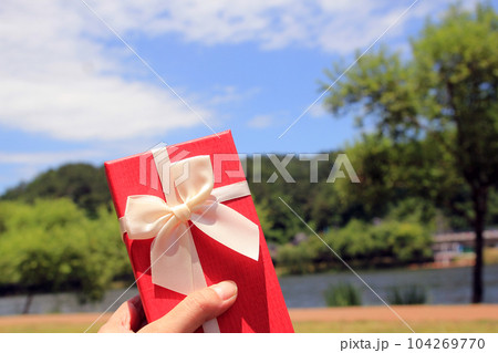 The theme of celebrations and gifts: Various shots of gift boxes with sunlight on the park lawn on a summer sunny day The theme of celebrations and gifts: Various shots of gift boxes with sunlight on the park lawn on a summer sunny day 104269770