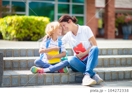 School pick up. Mother and kids after school. School pick up. Mother and kids after school. 104272338