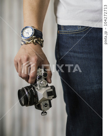 Right hand holding camera with watch and bracelet Right hand holding camera with watch and bracelet 104272713