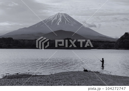 Japanese man fishing on Shoji lake with mt. Fuji view, Yamanashi Japanese man fishing on Shoji lake with mt. Fuji view, Yamanashi 104272747