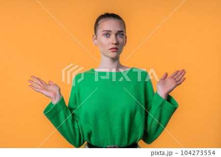 Confused pretty woman, shoulders up - can't help, makes gesture of I dont know 104273554