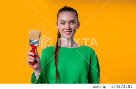 Young woman artist with brush on yellow background.Creative person fantasy, idea Young woman artist with brush on yellow background.Creative person fantasy, idea 104273583