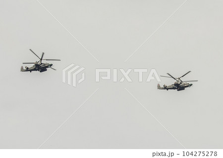 Two military helicopters Ka-52 Alligator Air Force VCS of Russia fly against the sky Two military helicopters Ka-52 Alligator Air Force VCS of Russia fly against the sky 104275278