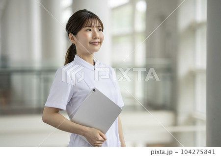 タブレットを持った笑顔の白衣の女性 ポートレート タブレットを持った笑顔の白衣の女性 ポートレート 104275841