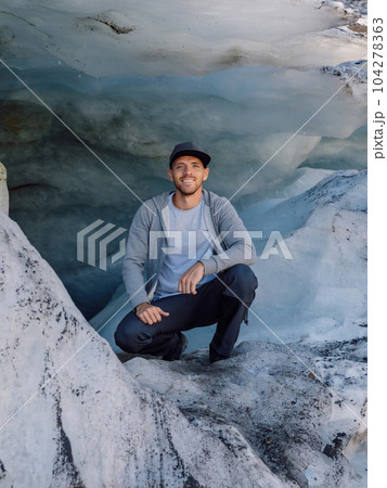 Smiling hiker man under big glacier. Glacier and caucasian tourist 104278363
