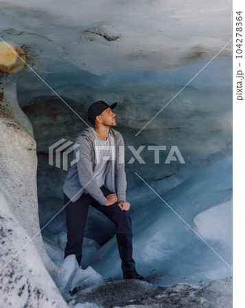 Smiling hiker man under big glacier. Glacier and caucasian tourist 104278364