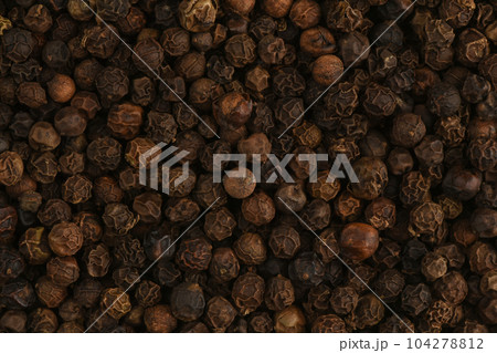 Black peppercorn close up. Macro texture of black hot pepper. Macro spice background. Black peppercorn close up. Macro texture of black hot pepper. Macro spice background. 104278812