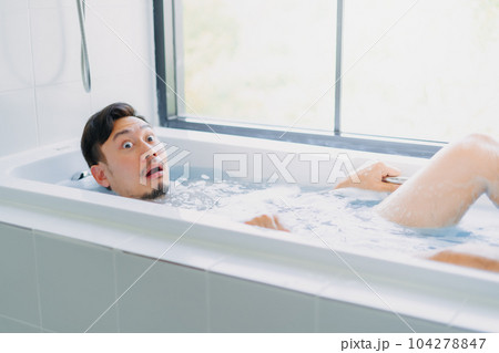 Funny asian man play and pose in the bathtub bathroom. 104278847
