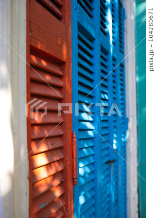 beautiful bright colorful and authentic red and blue shutters of ancient houses beautiful bright colorful and authentic red and blue shutters of ancient houses 104280671