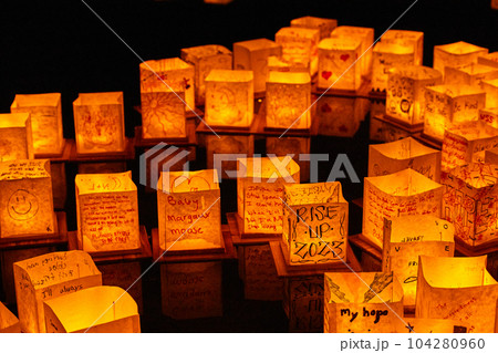 Wall of glowing golden Japanese style lanterns at festival Wall of glowing golden Japanese style lanterns at festival 104280960