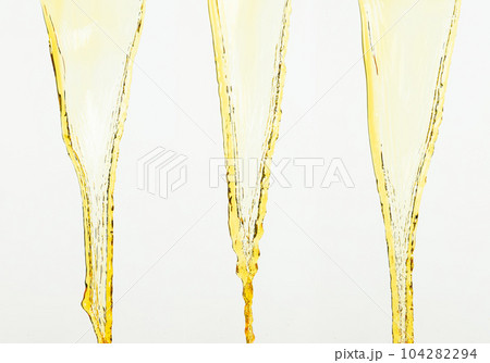 Orange, lemon juice or oil lubricant splash, liquid gold yellow drink drops. Fruit beverage water elements in line form . Fresh splashing and flowing jets, white background isolated freeze motion Orange, lemon juice or oil lubricant splash, liquid gold yellow drink drops. Fruit beverage water elements in line form . Fresh splashing and flowing jets, white background isolated freeze motion 104282294