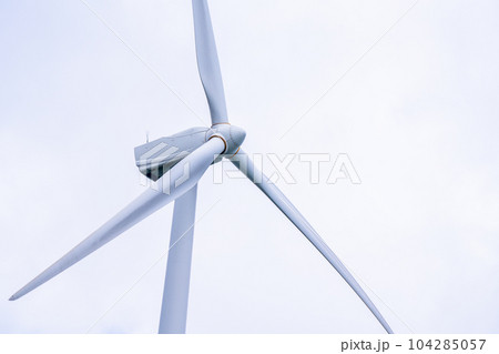 Close up of Wind turbine generating electricity clean energy with cloud background on the sky. Clean energy concept. Close up of Wind turbine generating electricity clean energy with cloud background on the sky. Clean energy concept. 104285057