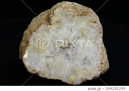 Quartz secretion with a polished cut on a black background 104285295
