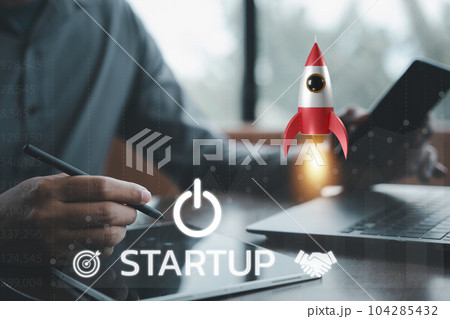 Business startup concept with a businessman controlling a white rocket icon that is taking off from a laptop into space, symbolizing the limitless potential of technology and innovation. 104285432