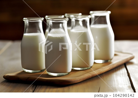 Glass bottles of fresh milk stand out, looking lovely and tasty Glass bottles of fresh milk stand out, looking lovely and tasty 104290142