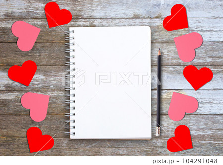 Blank notebooks or notepad,cup of coffee,red heart on wood table background 104291048