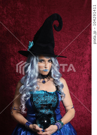 Woman Dressed as Blue Witch Holding Crystal Ball Woman Dressed as Blue Witch Holding Crystal Ball 104291411