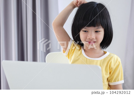 little asian girl student study online using laptop computer at home 104292012