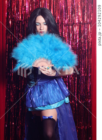 Woman Wearing Blue Corset Preforming Burlesque Dance With Feather Fan 104292109