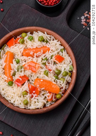 Delicious boiled rice with vegetables or risotto with salt, spices and herbs 104292718