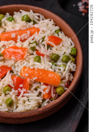 Delicious boiled rice with vegetables or risotto with salt, spices and herbs 104292726