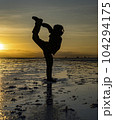 Sillouette of acrobat at sunrise on Bolivia Salt Flats 104294175