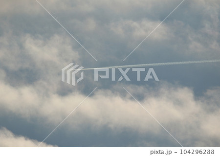A plane and vapor trails in the sky 104296288