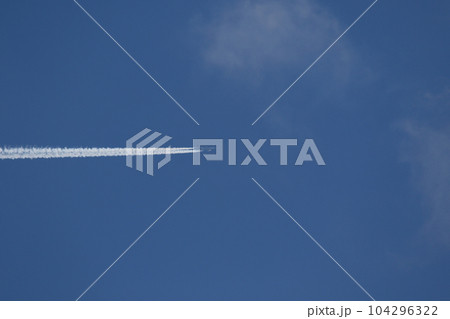 A plane and vapor trails in the sky 104296322