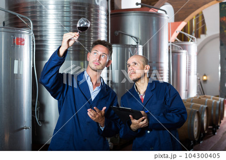 Workers taking notes wine sample Workers taking notes wine sample 104300405