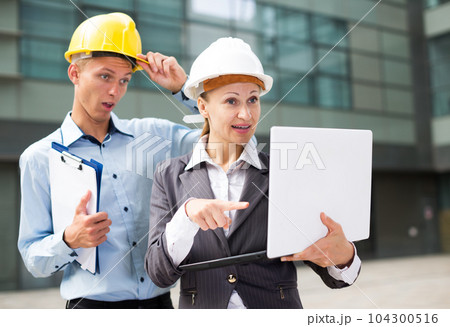 Woman designer and her partner are exploring project in laptop Woman designer and her partner are exploring project in laptop 104300516