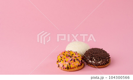 Cupcakes with confectionery decor on a pink background - sweets Cupcakes with confectionery decor on a pink background - sweets 104300566