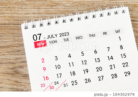 The July 2023 desk calendar for 2023 on wooden background. The July 2023 desk calendar for 2023 on wooden background. 104302979