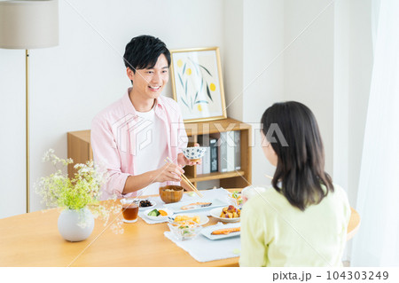 ダイニングで食事をする若い夫婦 104303249