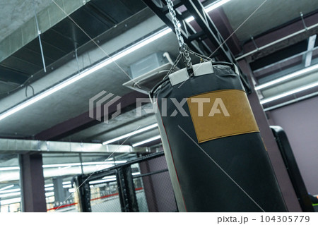 A closeup of a boxing punching bag in the sports complex A closeup of a boxing punching bag in the sports complex 104305779