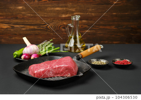 Uncooked beef steak boneless on frying pan 104306530