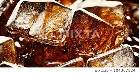 Cola with Ice. Close up of the ice cubes in cola water. Texture of carbonate drink with bubbles in glass. Cola soda and ice splashing fizzing or floating up to top of surface. Cold drink background. Cola with Ice. Close up of the ice cubes in cola water. Texture of carbonate drink with bubbles in glass. Cola soda and ice splashing fizzing or floating up to top of surface. Cold drink background. 104307924