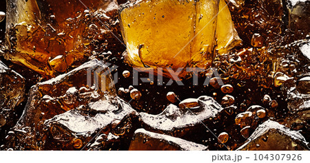 Cola with Ice. Close up of the ice cubes in cola water. Texture of carbonate drink with bubbles in glass. Cola soda and ice splashing fizzing or floating up to top of surface. Cold drink background. Cola with Ice. Close up of the ice cubes in cola water. Texture of carbonate drink with bubbles in glass. Cola soda and ice splashing fizzing or floating up to top of surface. Cold drink background. 104307926