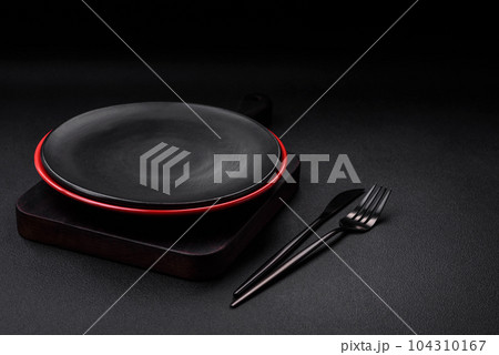 Empty ceramic plate on dark textured concrete background 104310167
