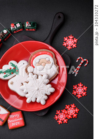 Beautiful bright colorful homemade gingerbread cookies on a ceramic plate 104310272
