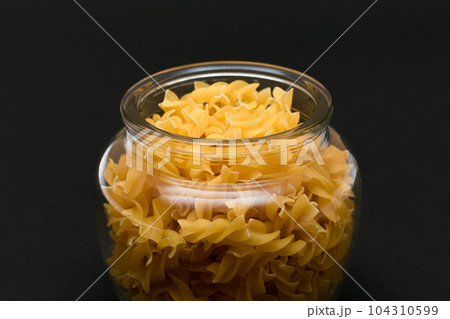 Uncooked Fusilli Pasta in Glass Jar 104310599