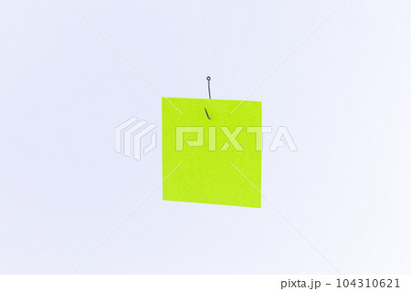 Mockup of a Blank Green Memo Paper with Copy Space Hanging on a Fishing Hook Mockup of a Blank Green Memo Paper with Copy Space Hanging on a Fishing Hook 104310621