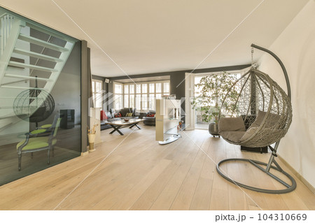 a living room with wood flooring and glass door leading to an open balcony area that looks out onto the street 104310669