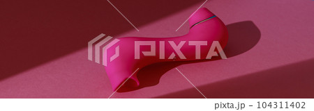Sex toy for women also called vacuum clitoral stimulator for satisfaction on pink background Sex toy for women also called vacuum clitoral stimulator for satisfaction on pink background 104311402